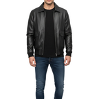 Man wearing a black leather jacket and blue jeans on a white background