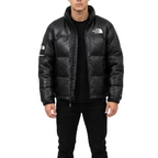 Person wearing a black leather jacket with a brand logo on a white background