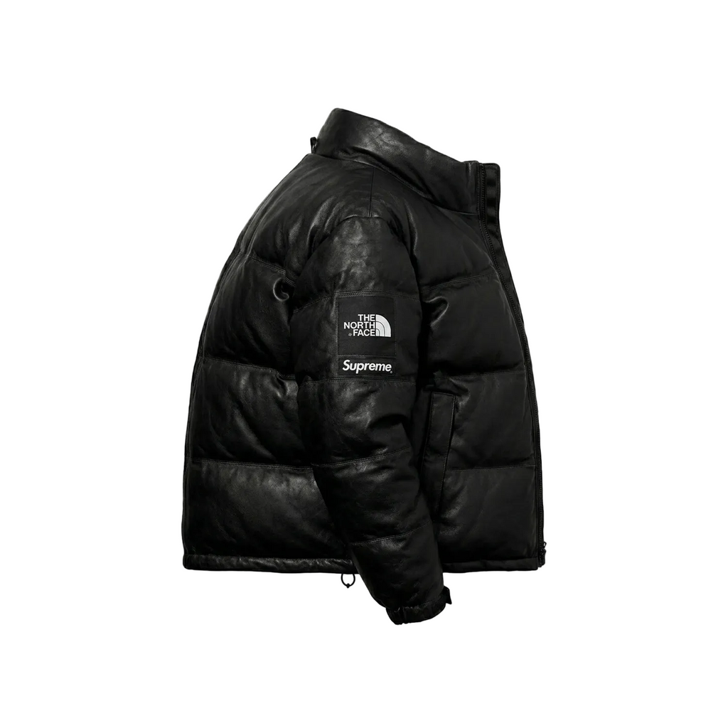 Black puffer jacket with Supreme logo on a white background