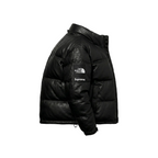 Black puffer jacket with Supreme logo on a white background