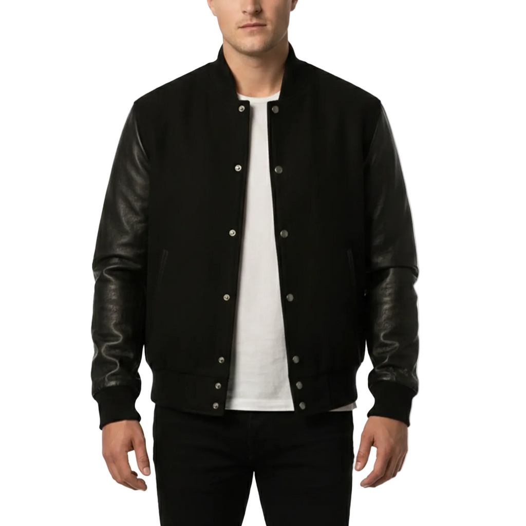 Man wearing a black varsity jacket with leather sleeves on a white background