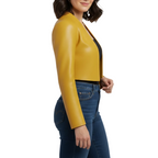 Woman wearing a yellow leather jacket and blue jeans on a white background